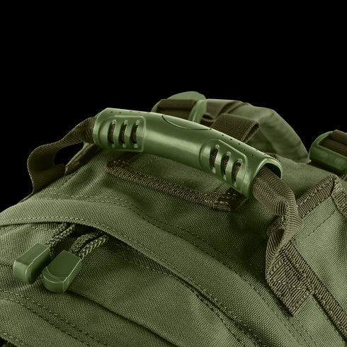 Close-up of the Condor Medium Assault Backpack 30L in green, highlighting its sturdy plastic handle, durable zipper pulls, and reinforced fabric stitching.